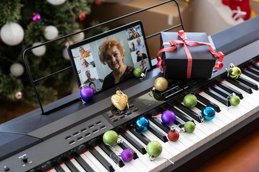 Black and white piano keys and tablet screen. The concept of online courses of the game fortepiano. christmas.