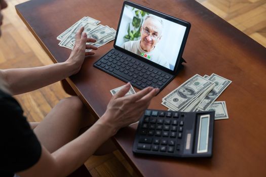 tablet screen and lot of hundred dollar bills. Business and social networking concept.