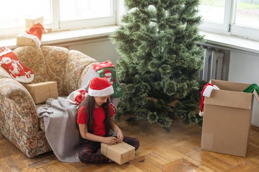 Happy little smiling girl with christmas gift box