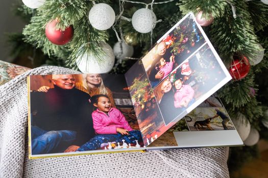 travel photo book near the Christmas tree
