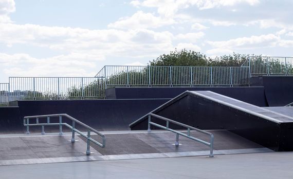 Skate park during the day. Empty, no people skating park. Skatepark ramps