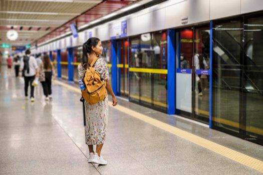 Bangkok Thailand, Portrait of Beautiful Asian woman tourist waiting for Skytrain at the railway station platform in the city. Confidence females enjoy city life lifestyle travel and shopping