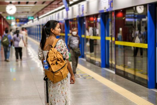 Bangkok Thailand, Portrait of Beautiful Asian woman tourist waiting for Skytrain at the railway station platform in the city. Confidence females enjoy city life lifestyle travel and shopping