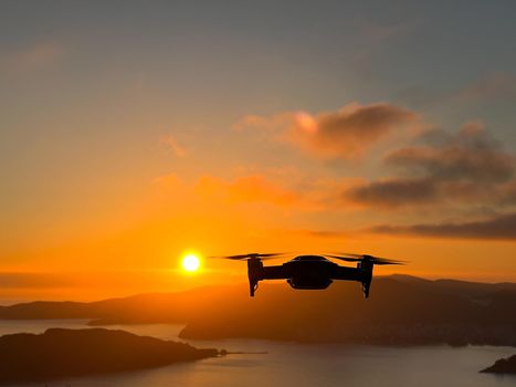 Drone filming the sea and mountains at sunset. High quality photo