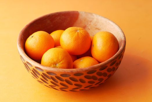 close up of slice of orange fruit in a bowl .