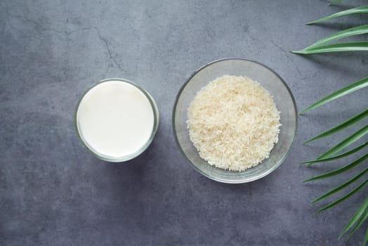 glass of milk and rice on a table, non dairy milk concept .