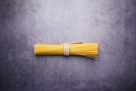 flat congestion of Yellow long spaghetti on black background ,
