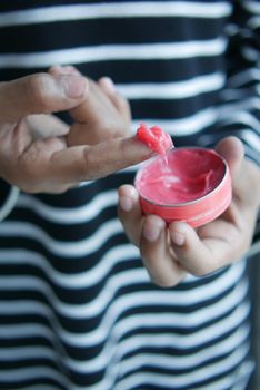 Close up of man hand using petroleum jelly .