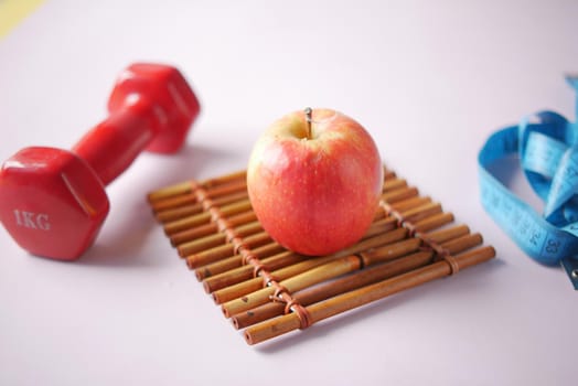 fresh drinking water and a pink color dumbbell on table ,