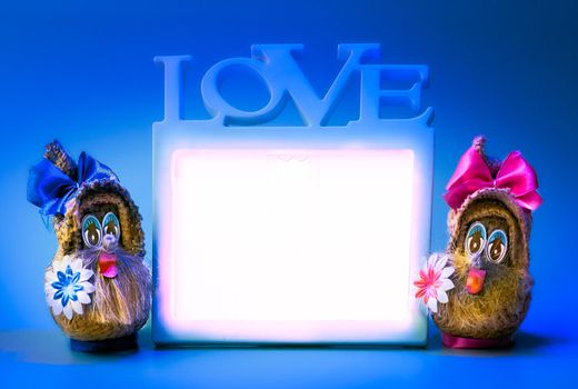 a rigid structure that surrounds or encloses something such as a door or window. Two funny gnomes and love frame on a blue background