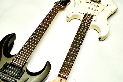 A stringed musical instrument, with a fretted fingerboard, typically incurved sides, and six or twelve strings, played with the fingers or a plectrum. Two guitar, neck fretboard