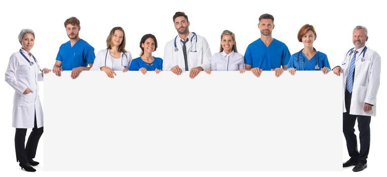 Group of doctors and nurses presenting empty banner. Isolated on white background, copy space for your text content