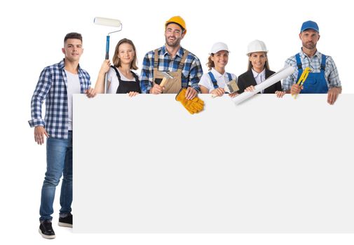 Portrait of happy construction workers holding blank banner isolated against white background