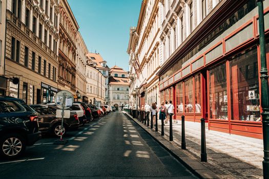 Beautiful cozy narrow street in old european city of Prague. Amazing architecture, historical facades of traditional buildings. High quality photo