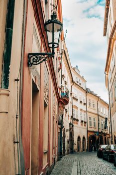 Prague, Czech Republic - July 2022. Beautiful cozy narrow street in old town. Amazing european architecture, historical facades of traditional buildings. High quality photo