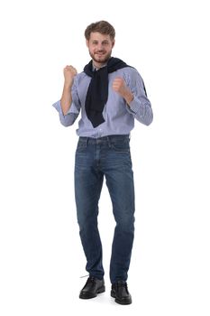 Full length portrait of excited business man holding clenched fists up in winner gesture, says yes I did it, isolated on white background