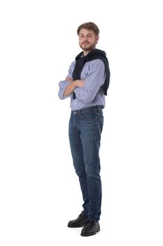 Full length portrait of young business man in casual clothes standing with arms folded isolated on white background