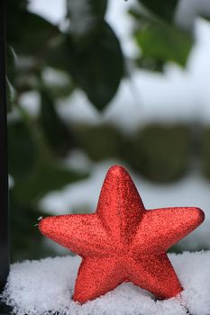 Red star ornament in fresh fallen snow