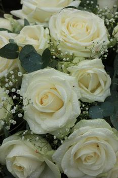 White roses and baby's-breath in a floral wedding decoration