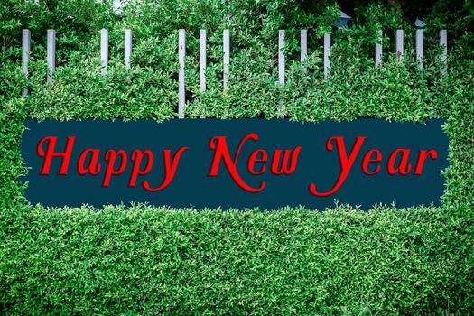 Happy new year texts logo on the framed by green leaves, use happy new year concept.