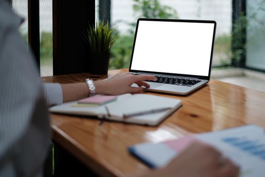 business woman sitting in office with laptop computer on desk.