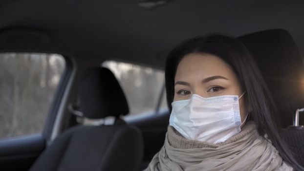 Female Doctor Driving A Car, Worried Asian Woman Looking At Camera Sitting In Car, Doctor In Protective Mask Is Afraid To Go To Work During Coronavirus Pandemic