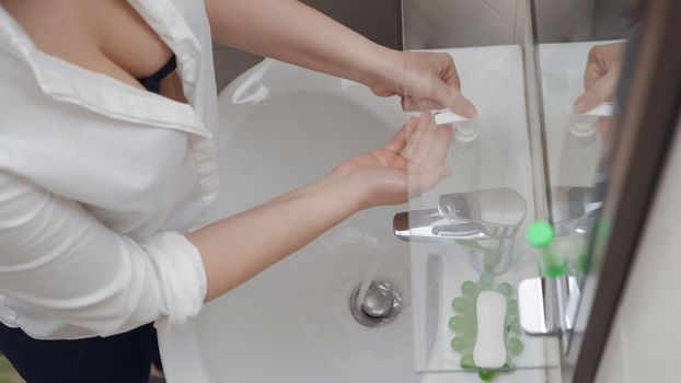 Woman Puts Antibacterial Soap On Her Hands, She Observe Preventive Actions In The Fight For Cleanliness And Being Health During The Coronavirus Epidemic, High Angle View