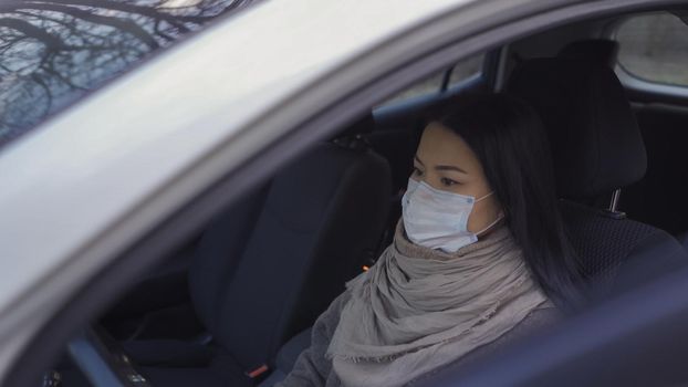 Female Taxi Driver In Protactive Mask Trying To Earn Money Using Her Car, Pretty Girl Asian Ethnicity Is Trying To Make Money During The Quarantine Using Her Car As Taxi