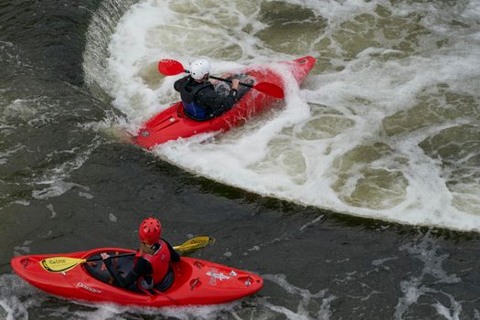 Bath, England, United Kingdom - August 4, 2021: Kayaking over Pulteney Weir on the River Avon in the historic city of Bath in the United Kingdom