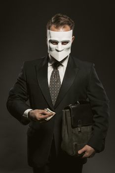 Businessman in white mask isolated on black in studio in beautiful style. Black background. White historical Italian mask on face. Protection concept.