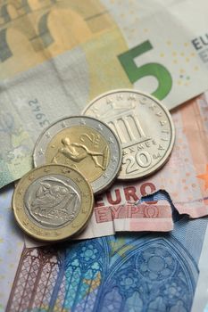Euro crisis, a vintage Greek Drachma coin and a torn euro note