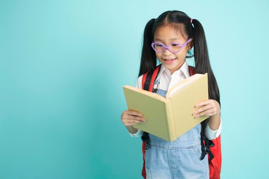 Close-up kid students girl smiling holding book, going to school. school concept.