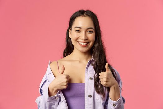 Sounds good Im in. Close-up portrait of satisfied, excited smiling beautiful asian girl in stylish outfit, recommend product, pleased with service or company, show thumbs-up, like and approve.