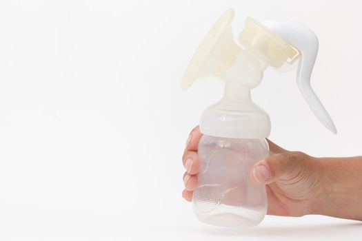 Isolated baby empty manual breast pump in cropped woman hand on white background with copy space