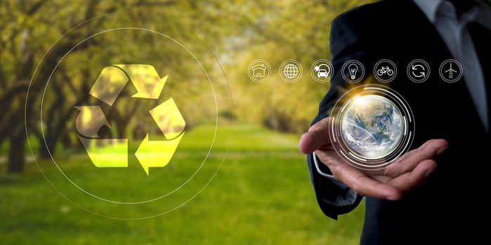 Environment concept Business man hold and show global with eco icon. business man using tablet to analyze environmental conservation industry Environmental protection business for a sustainable future