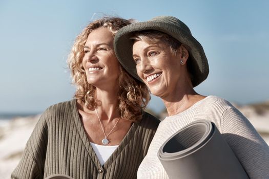 The views at the beach are breathtaking. two attractive mature woman standing with their on the beach