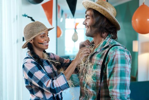 Were gonna be the best scarecrows. a young couple getting dressed for halloween at home