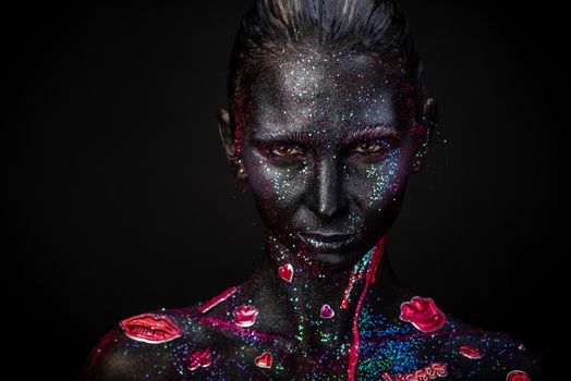 Mystical woman makeup with sparkles and luminous elements on a dark background