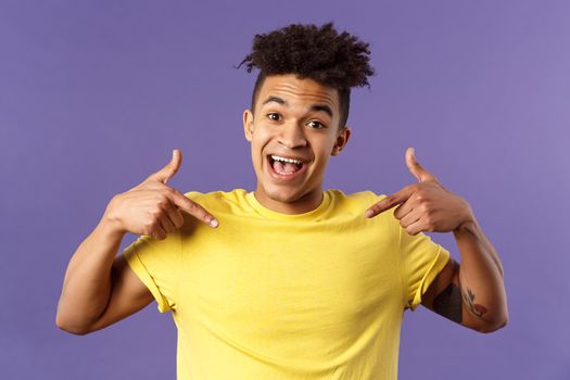 I am what you need. Close-up portrait of charismatic, cute smiling man boastful, proudly pointing at himself and talking won accomplishment, want to be candidate, participant, purple background.