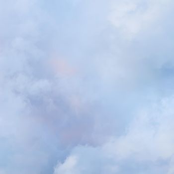 Background of cloudy sky with pale pink clouds at sunset