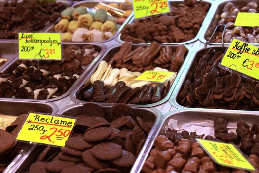 Chocolates on display on a confectioner's market stall (tags: prices and product information in Dutch)
