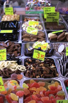 Chocolates and candy on display on a confectioner's market stall (tags: prices and product information in Dutch)