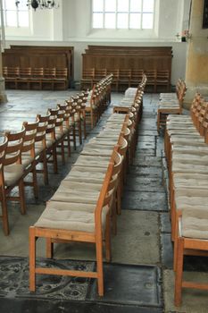 Simple wooden chairs in a Dutch Reformed Church