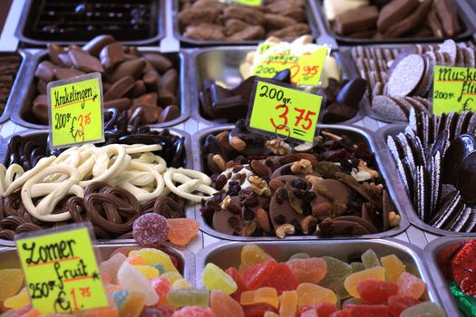 Chocolates and candy on display on a confectioner's market stall (tags: prices and product information in Dutch)