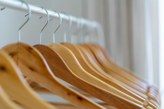 Close-up of wardrobe with wooden clothes hanger