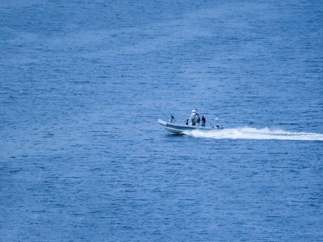 Ukraine-Russian conflict. Special forces men in camouflage uniforms on army motorboat. Boat moving across the river, diversionary mission,copy space. Military on an inflatable boat.