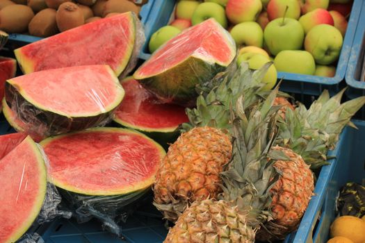 Fresh fruit on a market stall, watermelon and pineapples