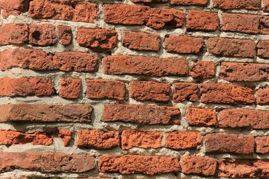 Vintage red bricks in an old brick wall