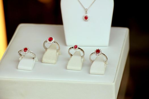 Classic Diamond engagement rings in a shop window, red ruby with diamond halo