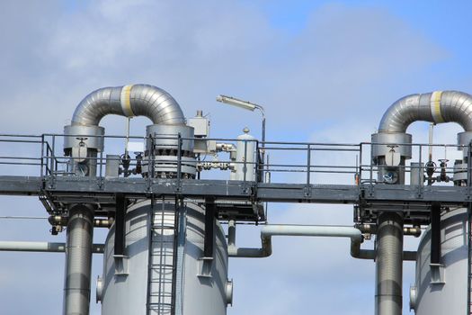 Silos and heavy metal pipes of an industrial plant, Chemical industrial industry